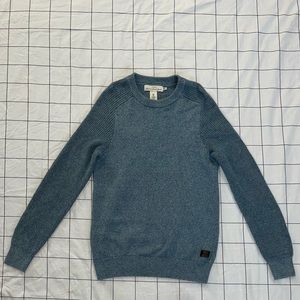 Label of Graded Goods teal crewneck sweater. Size Small